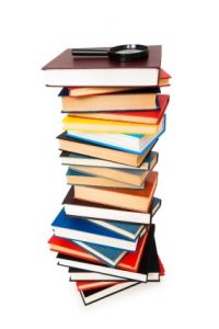 Magnifying glass over the stack of books